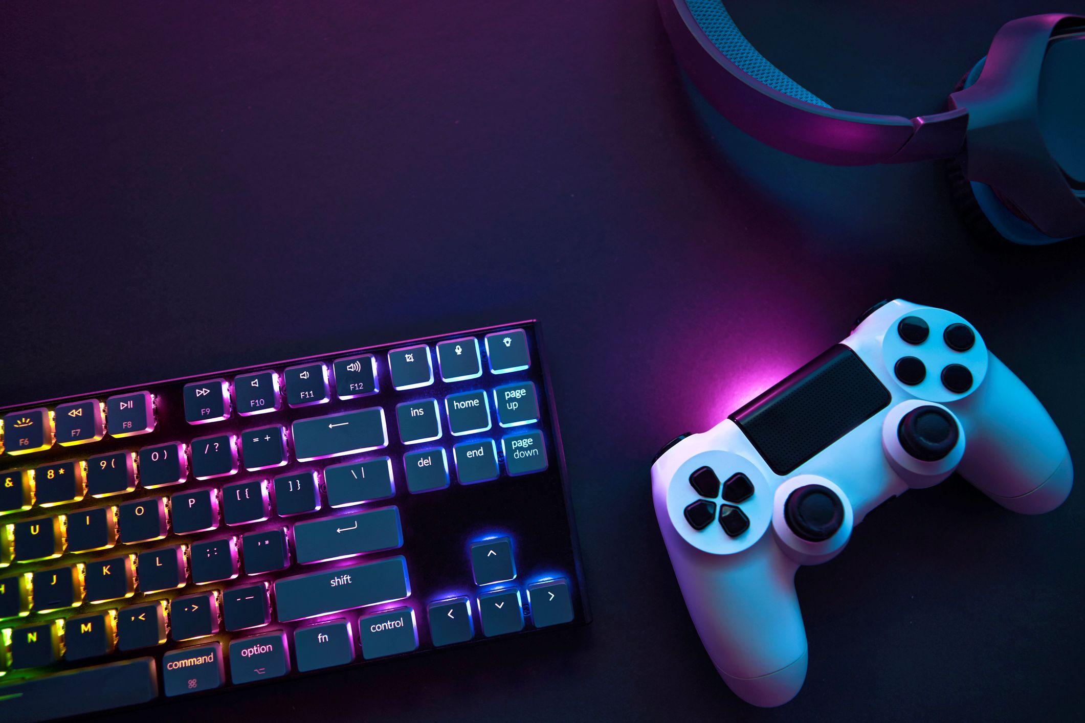 Top down view of colorful illuminated gaming accessories laying on table